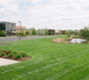 Immaculately maintained commercial lawn with professional mowing patterns outside a Western New York corporate business park in Amherst.