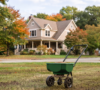 Amherst Landscaping professional performing fall overseeding on a residential lawn in Amherst.